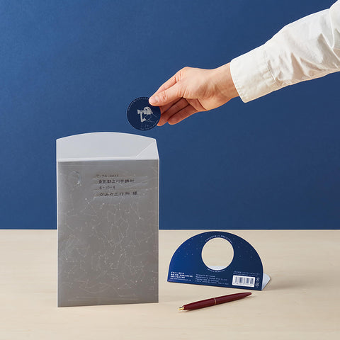 A breakdown of star filled envelope showing the envelope with written message to the receiver, the sticker logo and packaging