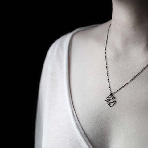 Worn close to the collarbone, the Moorigin Stainless Steel Pendant - Stone XS rests delicately on a fine chain, adding subtle geometric elegance