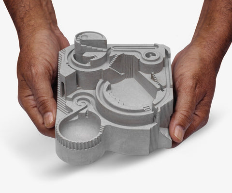 Gambol Brutalist Architectural Marble Run Sculpture—compact, tactile design with intricate paths where marbles glide through bold architectural forms