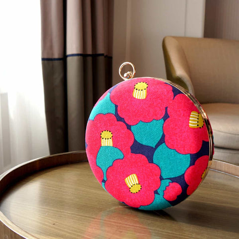 A front view of Cocoonese Round Hard Case Bamboo Handle Bag with Camellia Japonica (Pink) design