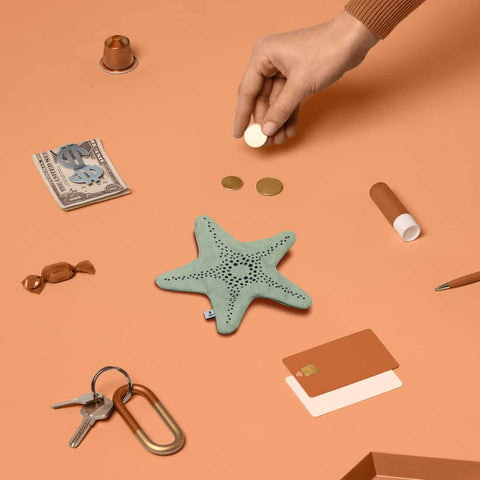 Don Fisher aqua starfish purse with a sea of keys, cards, sweets, cash, coins, limp bum, small items which can be fit into the purse