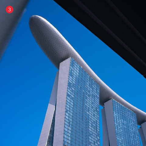 Part of Marina bay sands iconic building against a clear blue sky