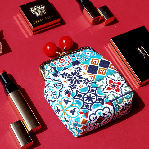 A top view of Cocoonese Clutch Purse Peranakan tiles which show the trinkets accessories which can be use as a small cosmetic bag 