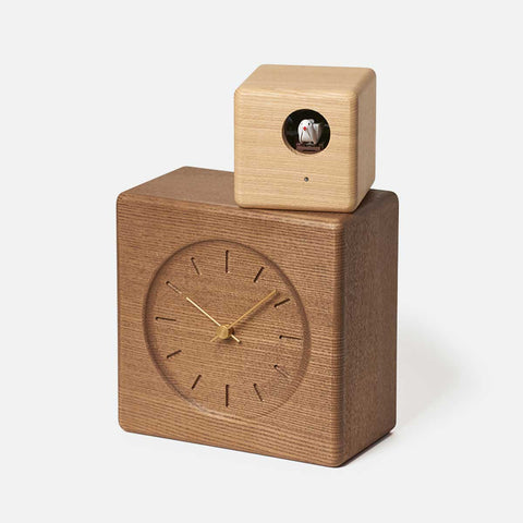 Lemnos Cubist Cuckoo Clock, dark wood square base with light wood cuckoo cube on top, on white background.