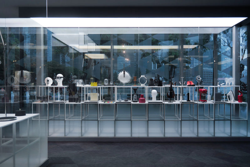 Product design exhibition on display inside a glass panel with Marina bay as background