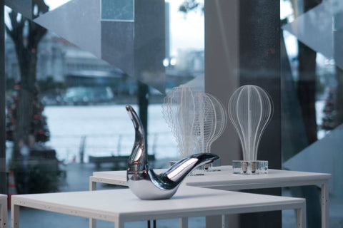 Award winning faucet display on a pedestal with a blurred Marina bay