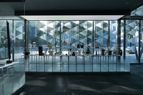 Red Dot Award Product design exhibition on display inside a glass panel with Marina bay as background