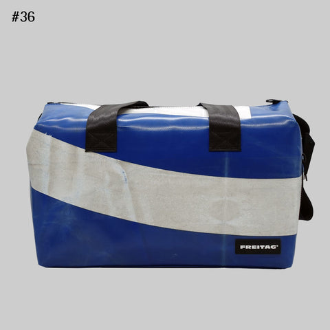 Front view of FREITAG F45 LOIS sports bag with black handles, blue and offwhite.
