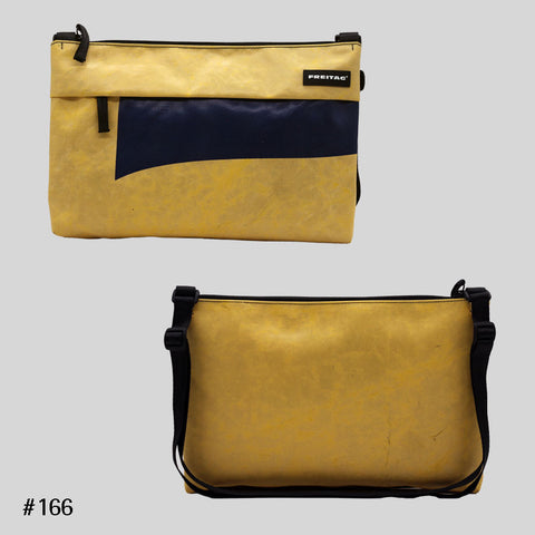 FREITAG F553 LOU shoulder bag in yellow with navy accent, upcycled truck tarp crossbody with adjustable strap, front and back views.