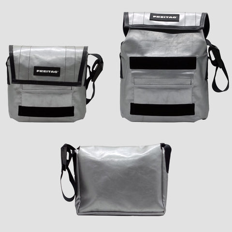 Front, extended and back views of FREITAG F11 LASSIE messenger bag in silver, with black trim and black strap.