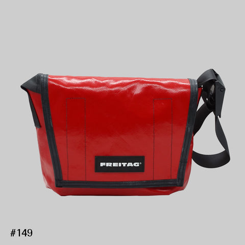 Front view of FREITAG F11 LASSIE messenger bag in red, with black trim and black strap