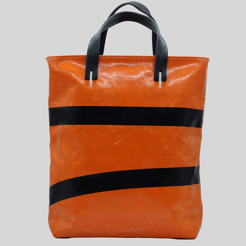 Back view of orange FREITAG F202 LELAND tote bag with black handles, two black stripes