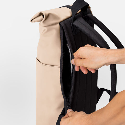 Person opening Hajo Mini Backpack Lotus Series from the side compartment for easy access