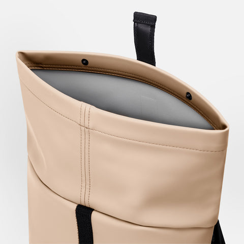 Showcasing Hajo Mini Backpack Lotus Series roll-top feature when its open up with button for further securing 