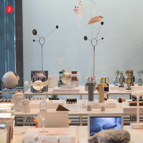 Design museum shop set up with white tops and colourful unique gifts and designer products on display 