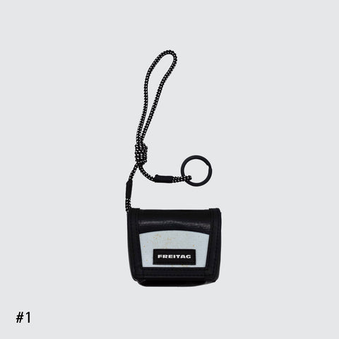 Front view of FREITAG F213 Mini Messenger key holder in black and white with nylon cord.