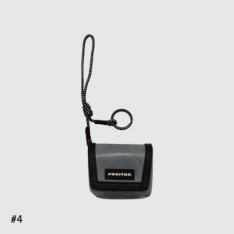 Front view of FREITAG F213 Mini Messenger key holder in grey with nylon cord.
