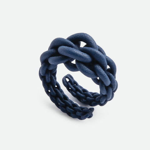 A 3D printed 'Magna' ring by Maison 203, in dark navy blue colour. Design is knotted chain ring.