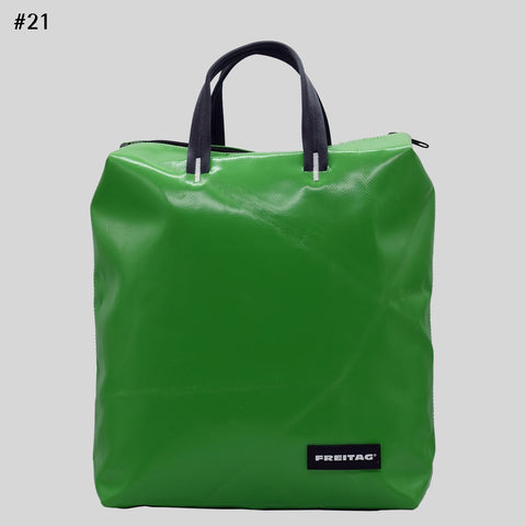 Front view of FREITAG F201 PETE backpack in green with black handles and glossy surface