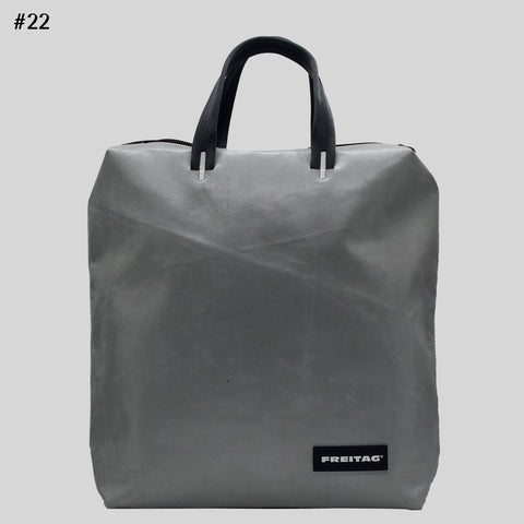Front view of FREITAG F201 PETE backpack in silver with black handles.