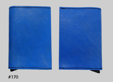 Front and back views of blue FREITAG F705 SECRID Slimwallet RFID wallet with black stitching and a metal card slider at the base.