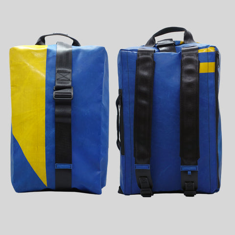 FREITAG F511 Skipper Large backpack in blue and yellow, upcycled truck tarp with padded straps, front and back views.
