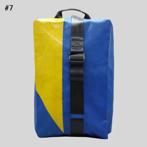 FREITAG F511 Skipper Large backpack in blue and yellow, upcycled truck tarp with adjustable buckle strap, front view.