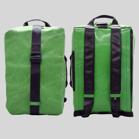 FREITAG F511 Skipper Large backpack in solid green, upcycled truck tarp with padded straps, front and back views.
