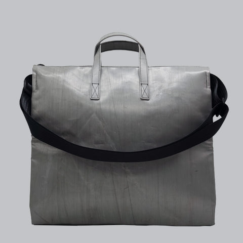 Back view of FREITAG F275 TILDA tote bag in silver, with silver handles and black shoulder strap