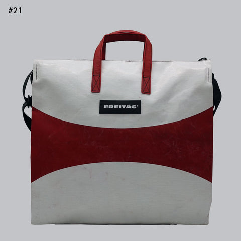 Front view of FREITAG F275 TILDA tote bag in white and red, with red handles and curved red band.