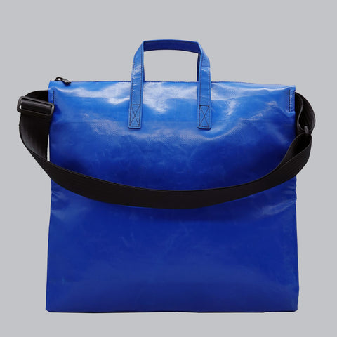Back view of FREITAG F275 TILDA tote bag in blue, with blue handles, black shoulder strap.