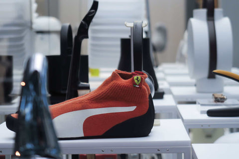 Red and black shoe with a white Puma logo showcasing the product PUMA evoKNIT Driver Pro